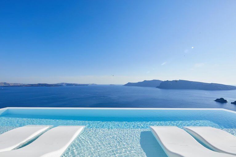 Infinity pool with views of Aegean Sea at luxury Canaves Oia Suites in Santorini